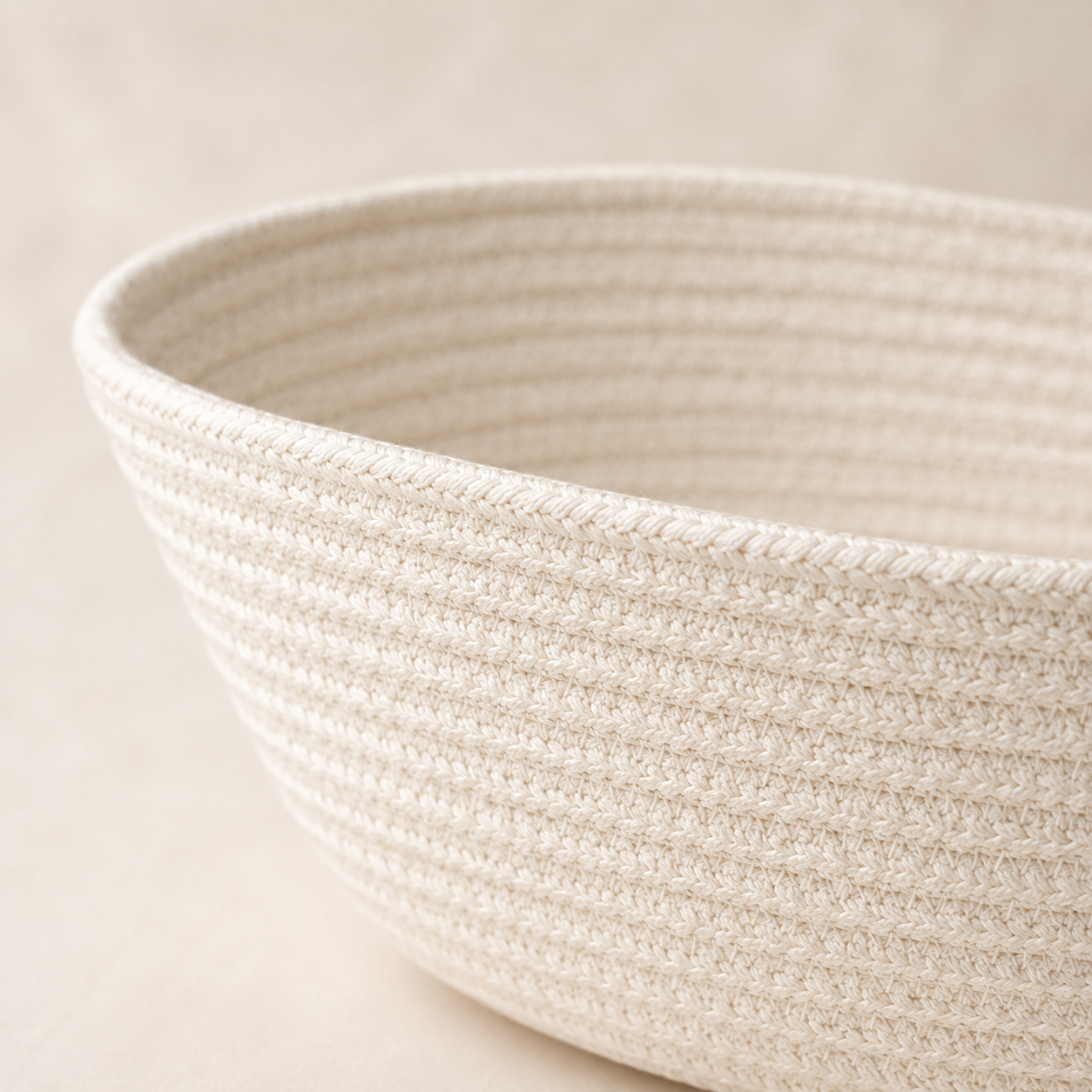Close-up of solid off-white cotton cord fruit basket texture